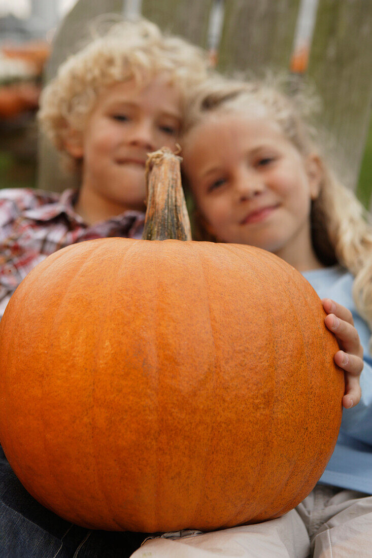 Brother and sister holding pumpkin, Virginia Beach, VA