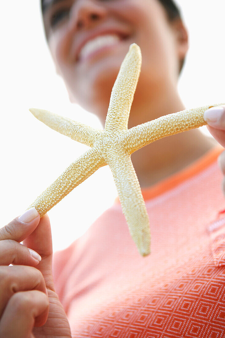 Woman holding starfish, Cape Cod, MA