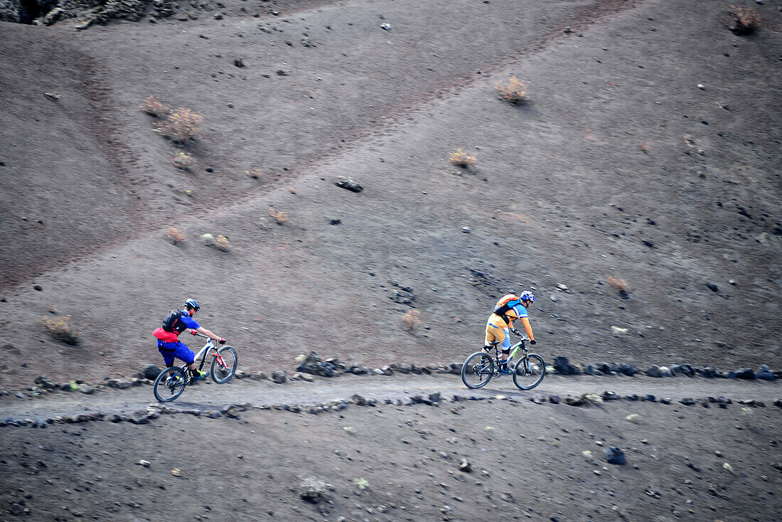 Mountain bikers off-roading, San Antonio volcano, La Palma, Canary Islands, Spain