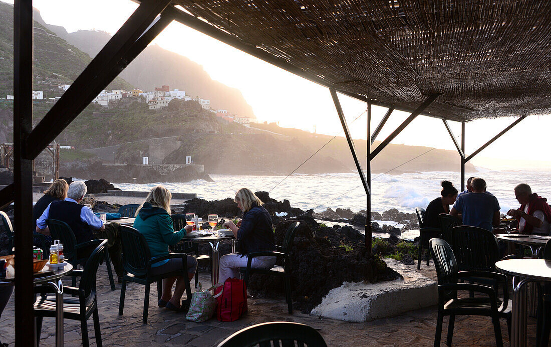 Guests in a cafe at coast, Garachico, Tenerife, Canary Islands, Spain