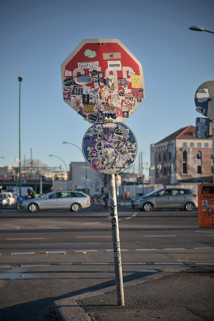 Sticker-plastered Stop sign, East Side Gallery, Berlin, Germany