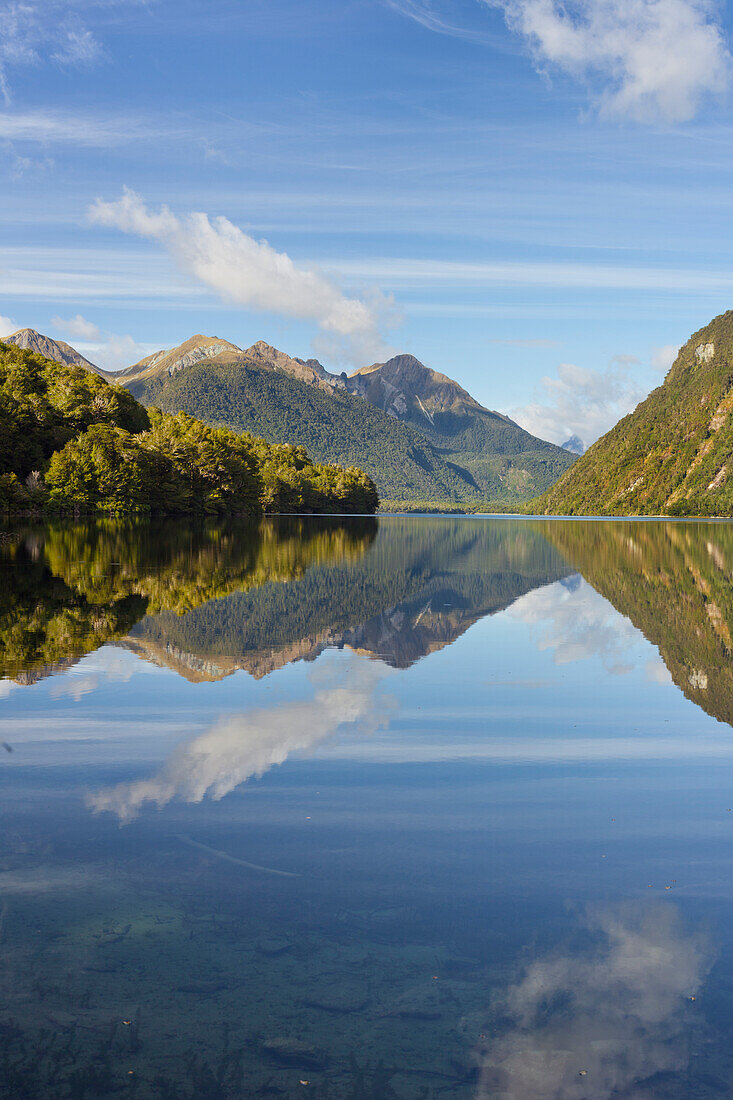 Reflection of the mountains in Lake Gunn, Fiordland National park, Southland, South Island, New Zealand