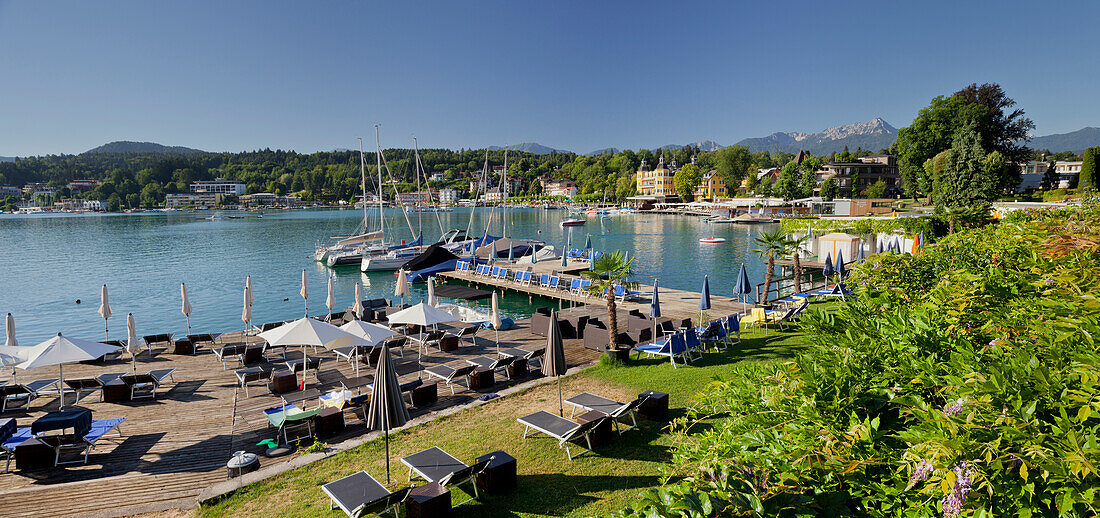 Velden castle with sun loungers and platform, Lake Woerthersee, Carinthia, Austria