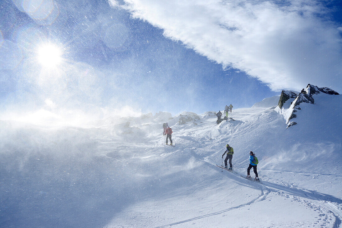 Back-country skiers ascending through snowstorm to Regenfeldjoch, Langer Grund, Kitzbuehel Alps, Tyrol, Austria