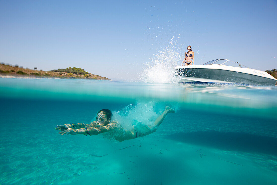 Man bathing in a lagoon, Diaporos Island, Vourvourou, Sithonia, Chalkidiki, Greece