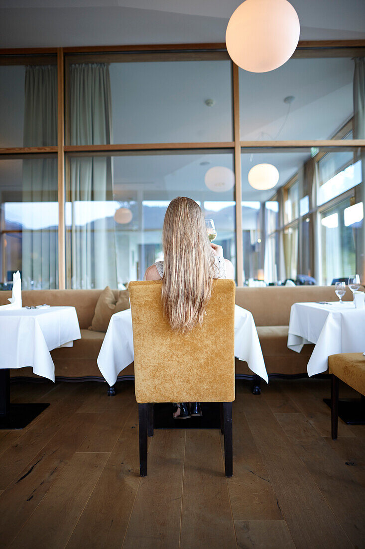 Woman in a hotel restaurant, Upper Bavaria, Germany