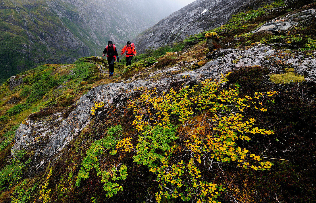 Two mountaineers ascending to the base camp of Monte Sarmiento, Cordillera Darwin, Tierra del Fuego, Chile