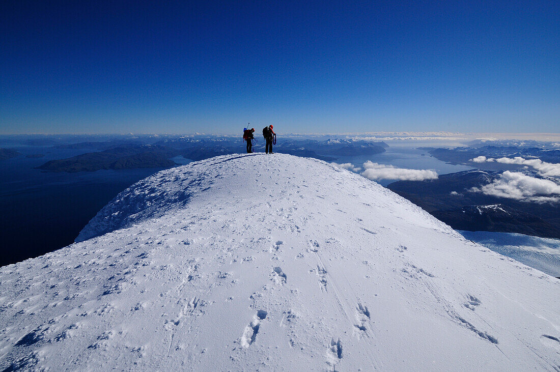 Two mountaineers at the west summit of Monte Sarmiento, Cordillera Darwin, Tierra del Fuego, Chile
