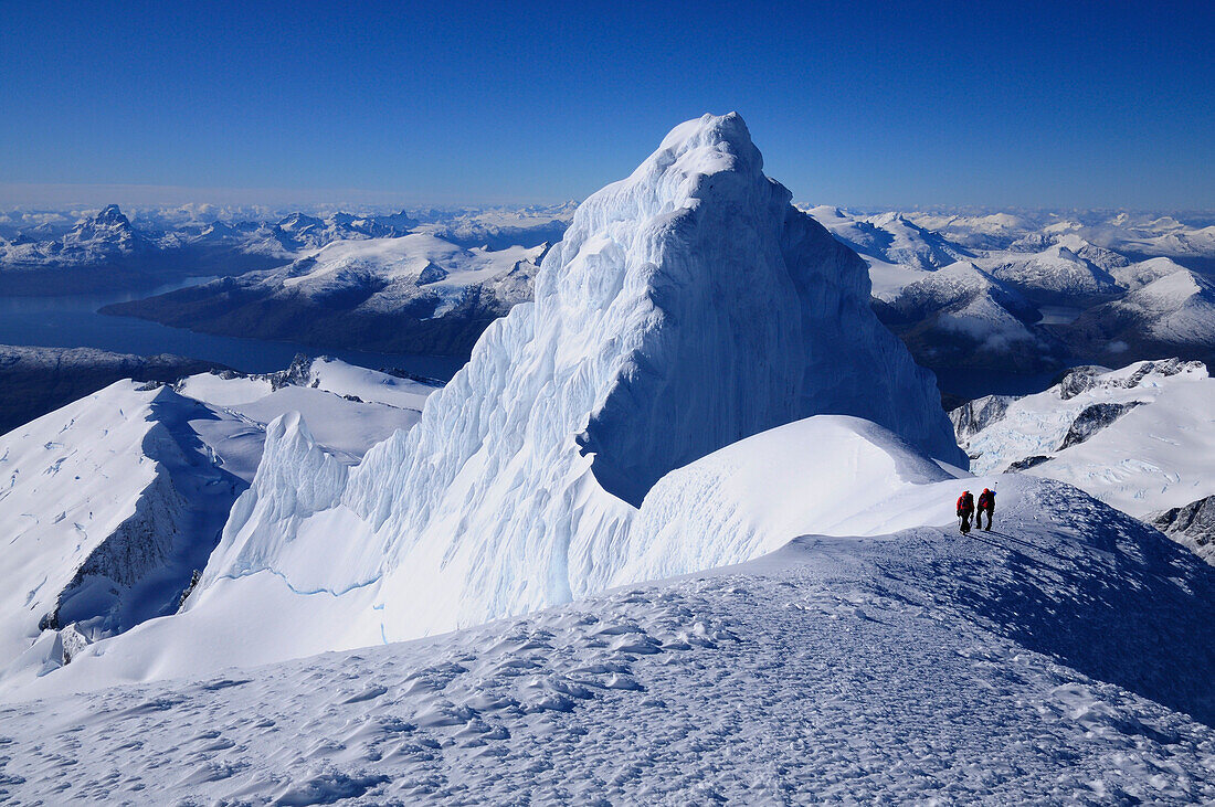 Two mountaineers below the west summit of Monte Sarmiento, Cordillera Darwin, Tierra del Fuego, Chile