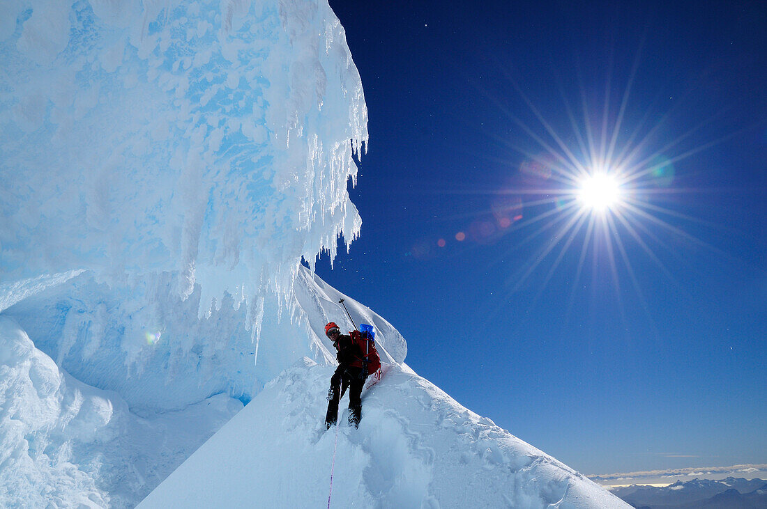 Mountaineer in a bergschrund of the north face of Monte Sarmiento, Cordillera Darwin, Tierra del Fuego, Chile