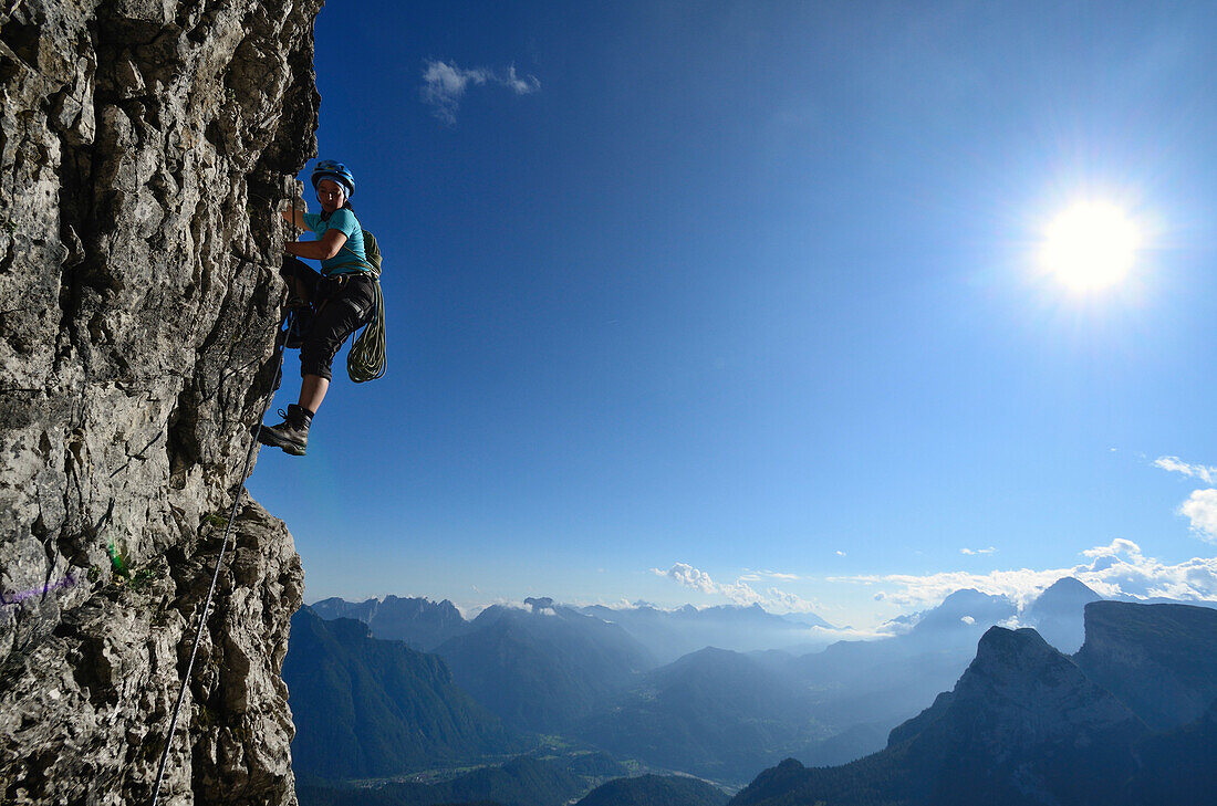 Woman ascending Via ferrata Gianni Constantini, Cima Moiazza, Dolomites, Veneto, Italy