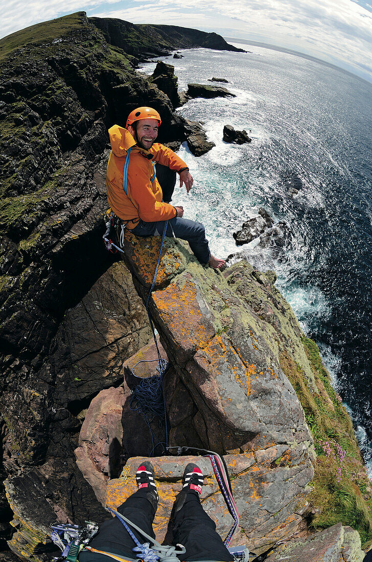 Climber on the top of Old Man of Stoer, Stoer, Highlands, Scotland, Great Britain