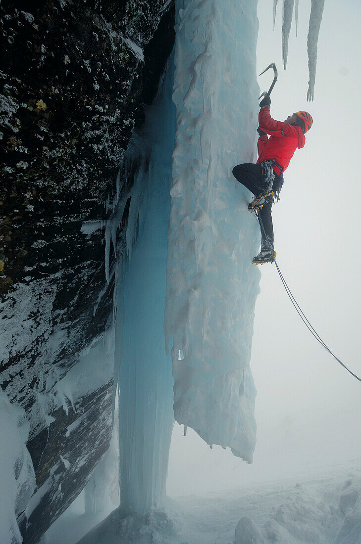 Ice climber with ice axe ascending Creag Meagaidh, Highlands, Scotland, Great Britain