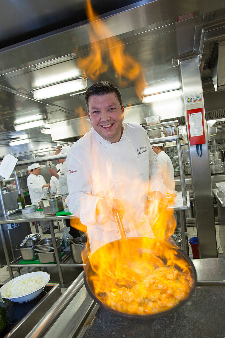 Executive Chef Erik Brack of the cruise ship MS Deutschland, Reederei Peter Deilmann, flambeing prawns in the galley kitchen, South China Sea, near Taiwan