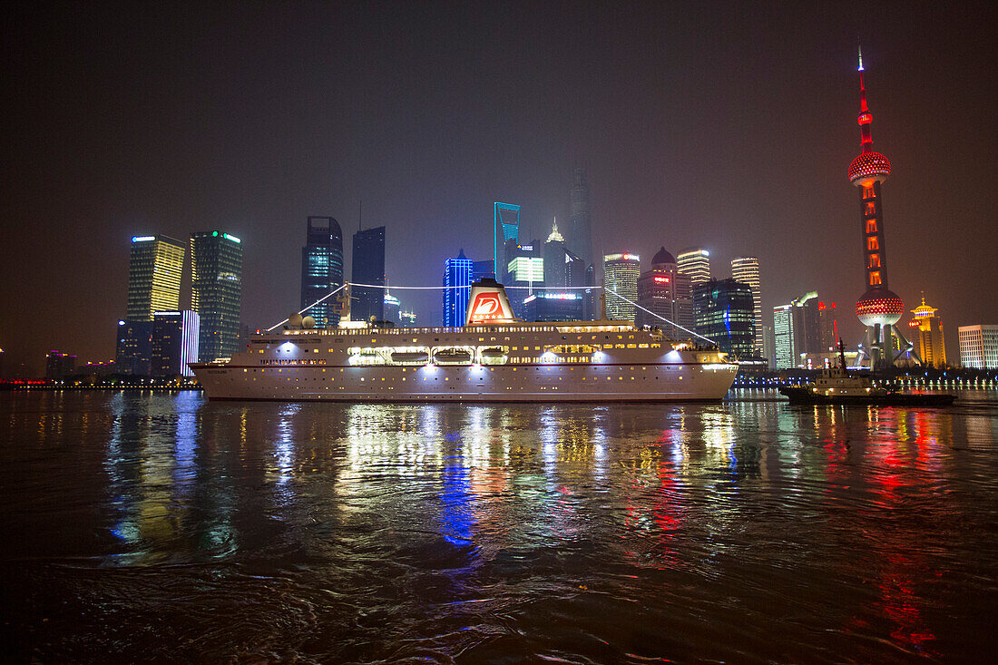 Cruise ship MS Deutschland, Reederei Peter Deilmann, on the Huangpu River with Oriental Pearl Tower and skyline at night, Shanghai, China