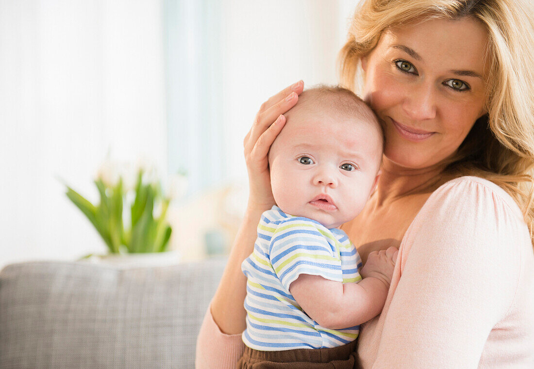 Caucasian mother smiling with baby, Jersey City, New Jersey, USA