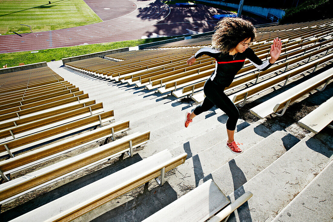 Mixed race runner training in stadium, Los Angeles, California, USA