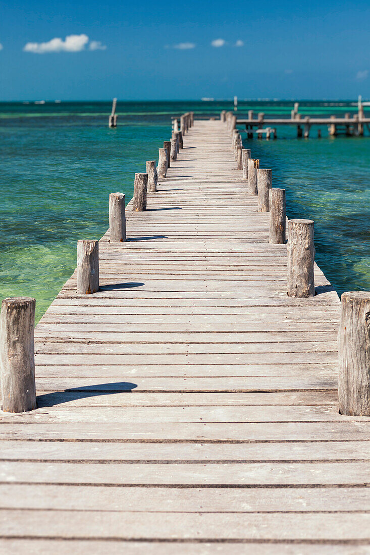 A long wooden jetty or pier, stretching out over the water at Cancun, Cancun, Quintana Roo, Mexico