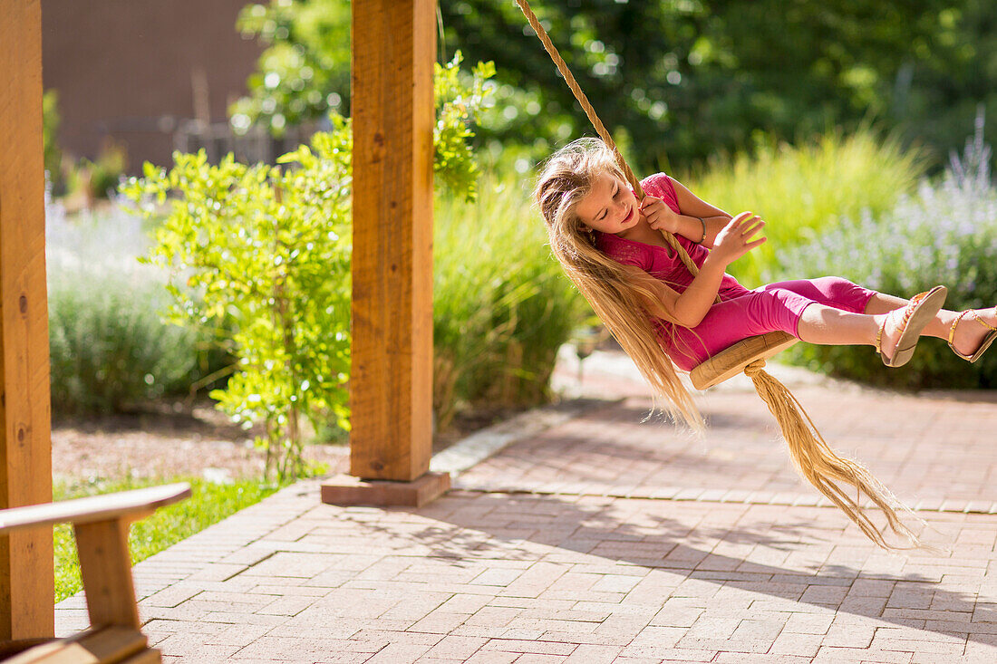 Caucasian girl on swing, Santa Fe, New Mexico, USA