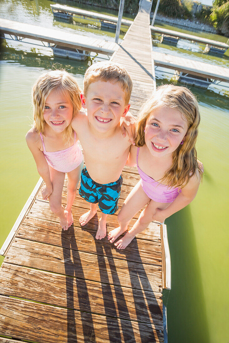 Caucasian children standing on dock, American Fork, Utah, USA