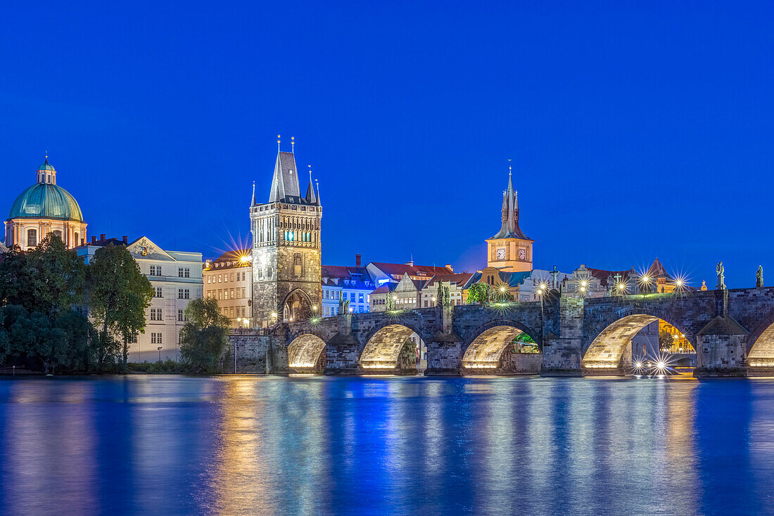 Charles Bridge and city illuminated at dusk, Prague, Czech Republic, Prague, Central Bohemia, Czech Republic