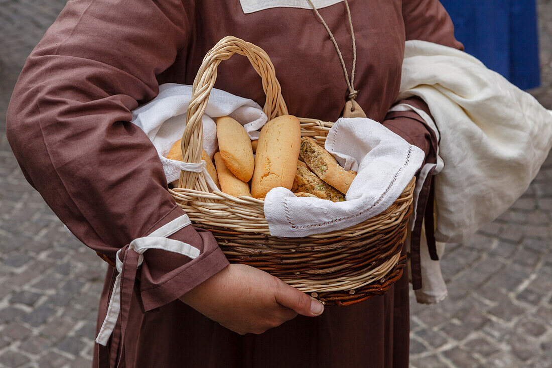 basket with bread, traditional medieval costume parade, city festival, tradition, Via del Duomo, pedestrian area, old town, Orvieto, hilltop town, province of Terni, Umbria, Italy, Europe