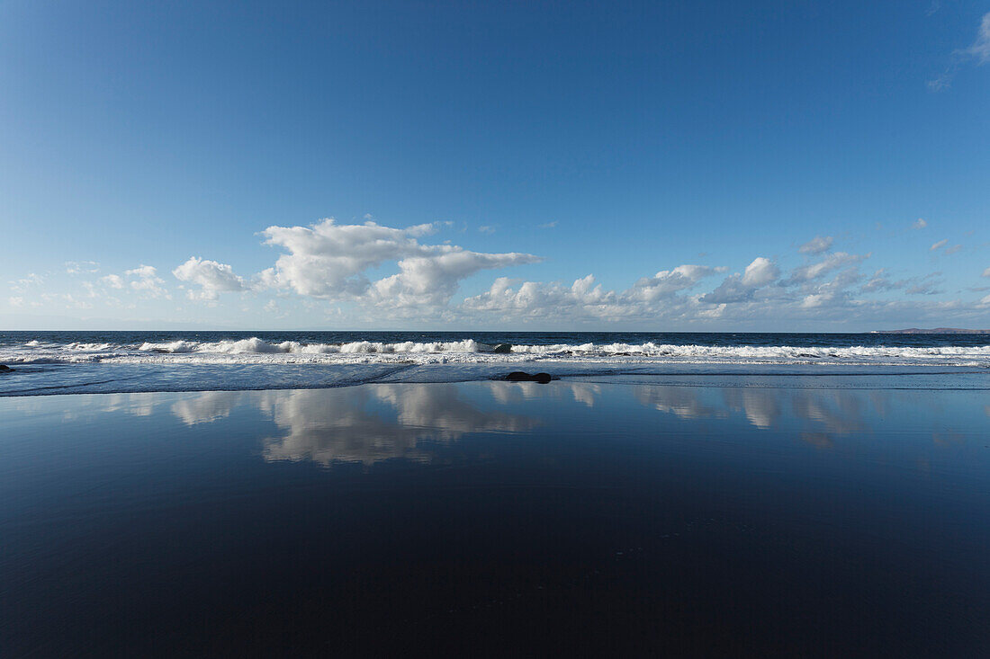 Cloud reflection on Playa del Risco, beach near Agaete, Atlantic ocean, Natural Preserve, Parque Natural de Tamadaba, UNESCO Biosphere Reserve, West coast, Gran Canaria, Canary Islands, Spain, Europe