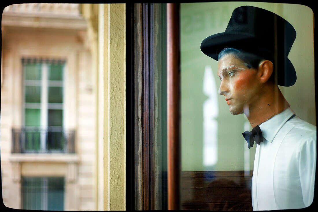 old male mannequin in a shop window of Bates hat shop in Rue de Rivoli, Paris, France