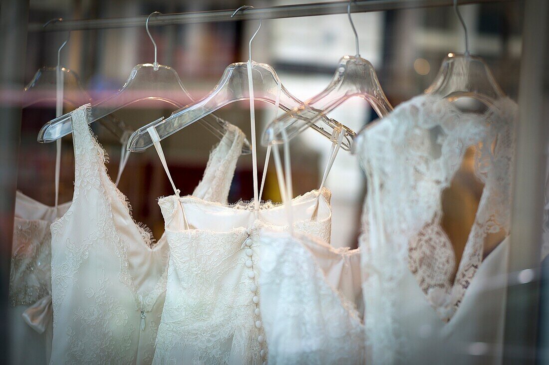 Wedding dresses hanging in various hangers