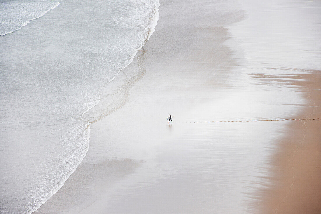 Person alone on beach, high angle