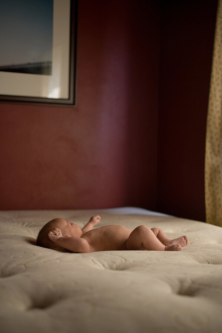 Newborn baby boy lying on back