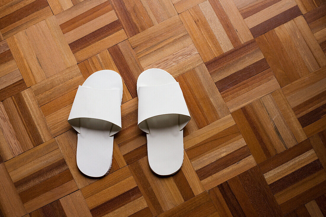 White slippers on wooden floor