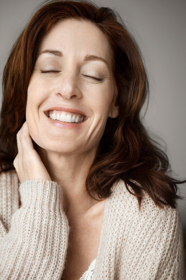 Happy and relaxed woman with closed eyes
