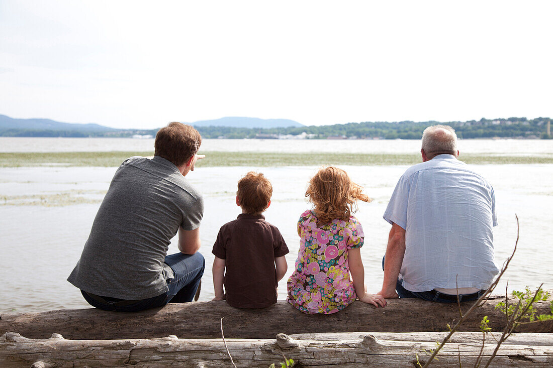 Children by river with father and grandfather