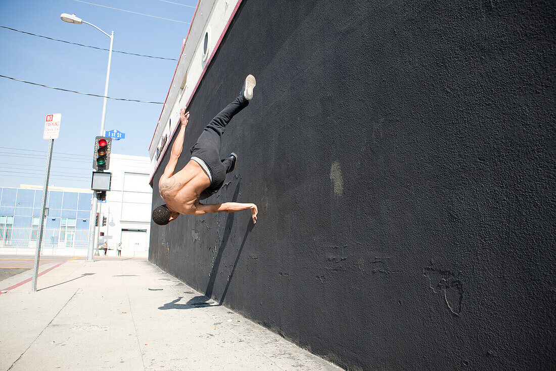 Man running up wall, demonstrating parkour