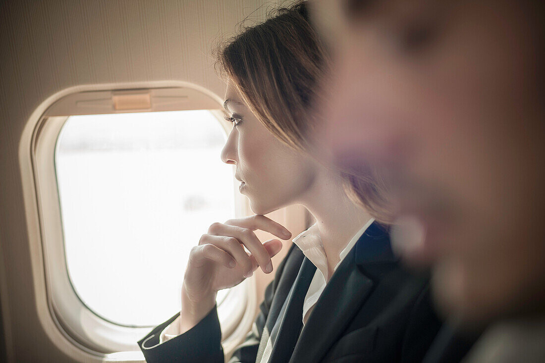 Female passenger looking out of aeroplane window