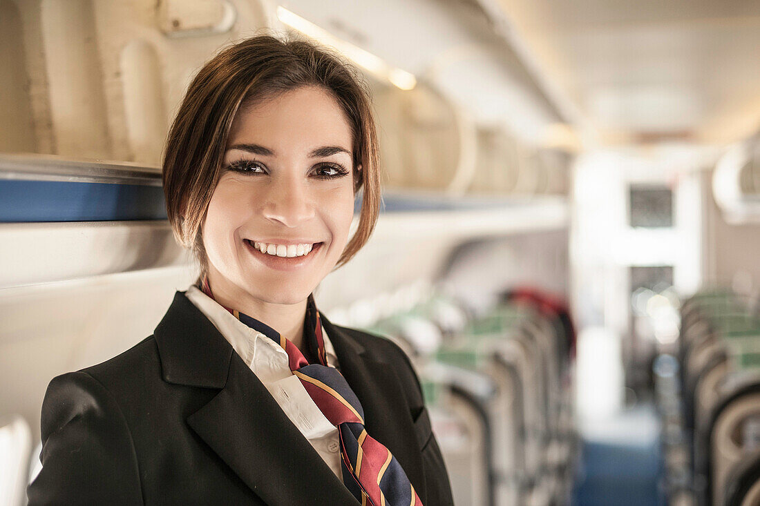 Portrait of air stewardess on aeroplane