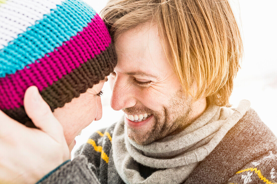Couple face to face, woman wearing knit hat