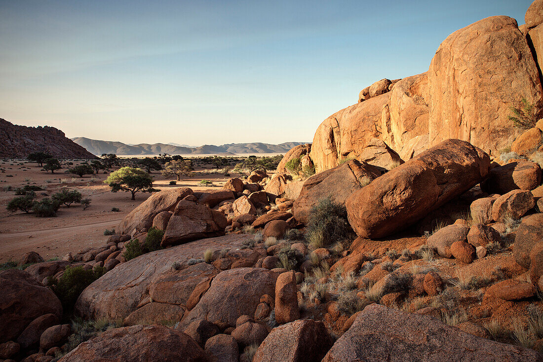 Panoramic view across red rocks towards the Tiras Mountain Range, Namib Naukluft National Park, Namibia, Africa