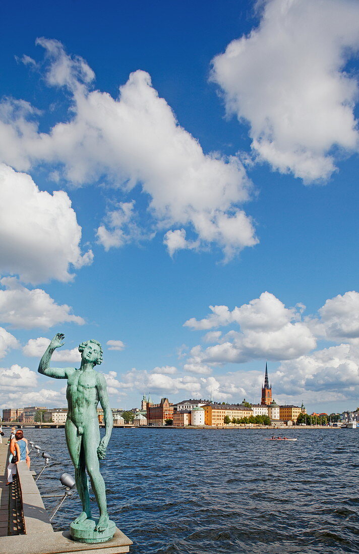Bronze Statue, Sangen in city hall garden and Riddarholmen with Riddarholmen church in the background, Stockholm, Sweden