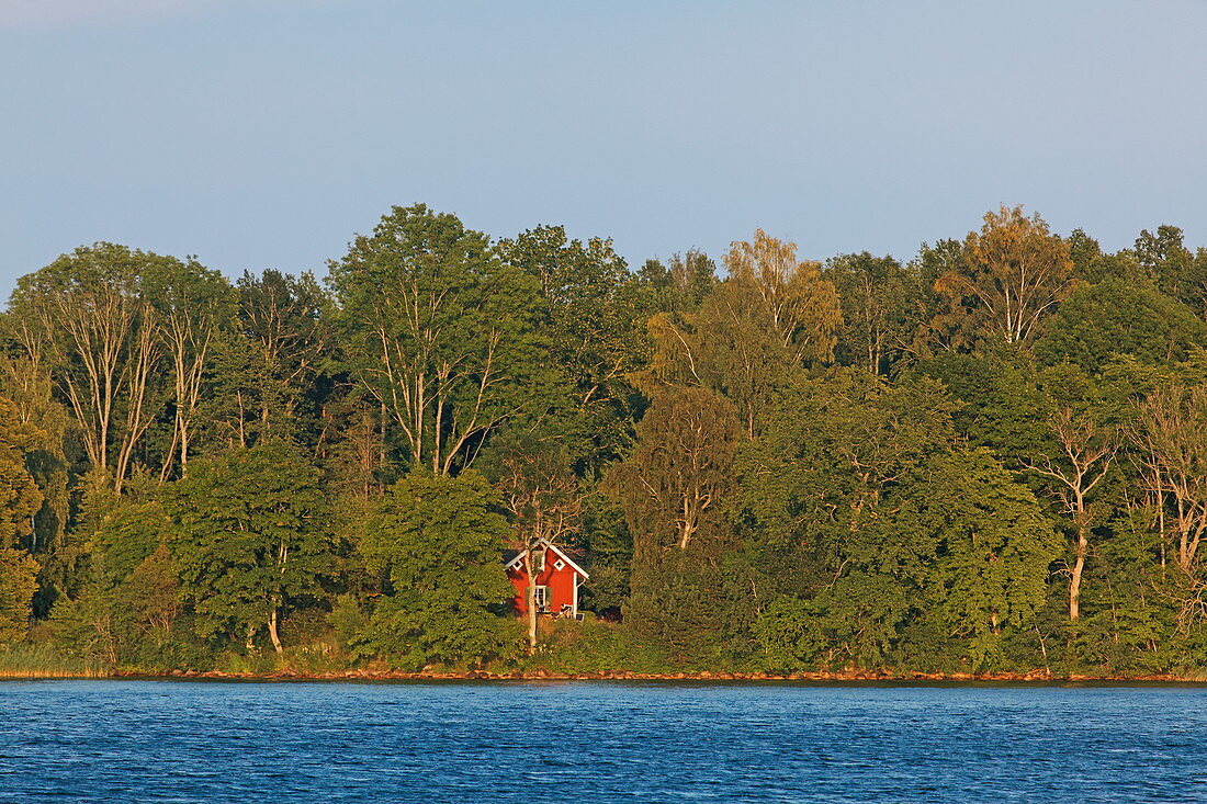 Red holiday home on the edge of lake Vaettern, Sweden