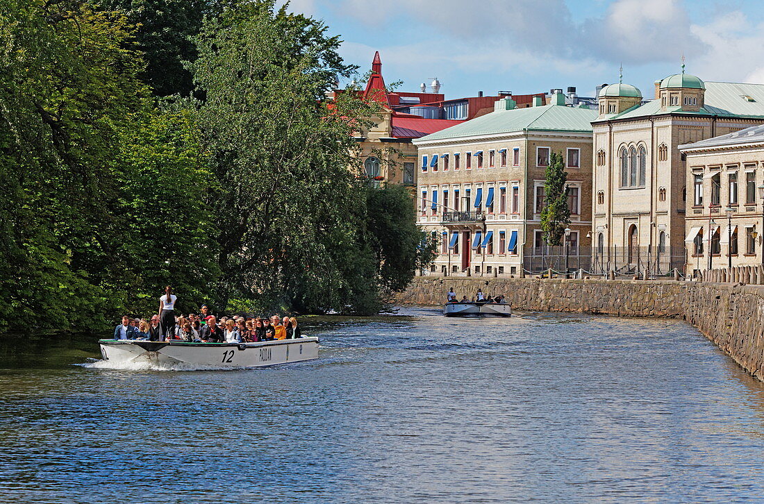 Tour boat in a canal at Wallgraben and historic facades of the old town, Gothenburg, Sweden