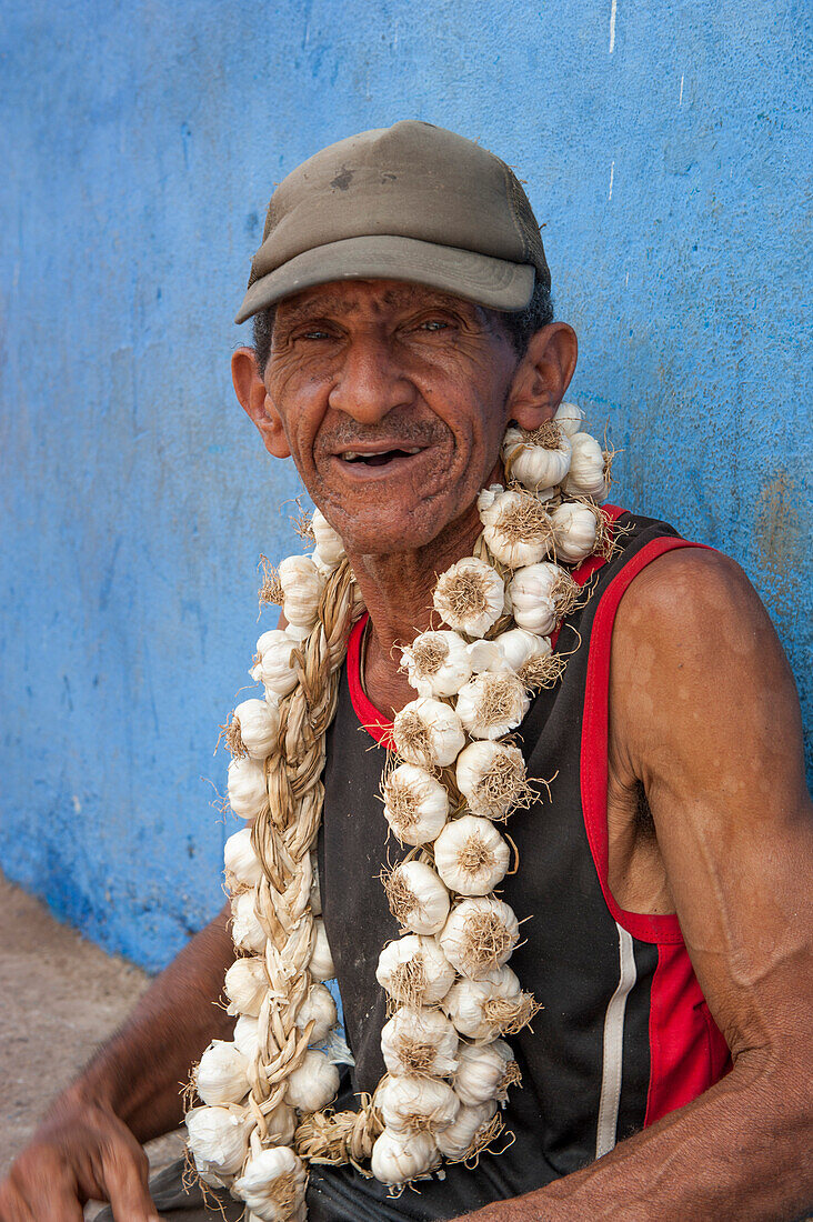 Man with garlic necklace at market, Santiago de Cuba, Santiago de Cuba, Cuba