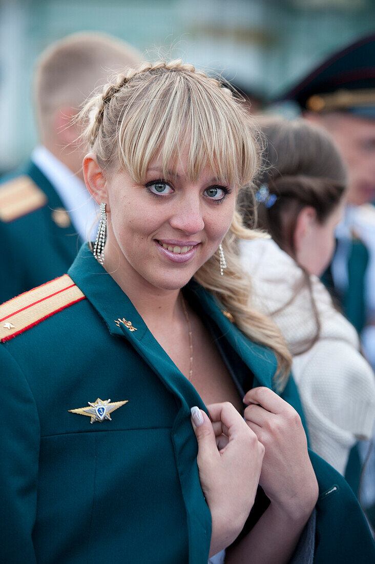 Woman wearing officer's jacket during a military parade in Palace square, St. Petersburg, Russia