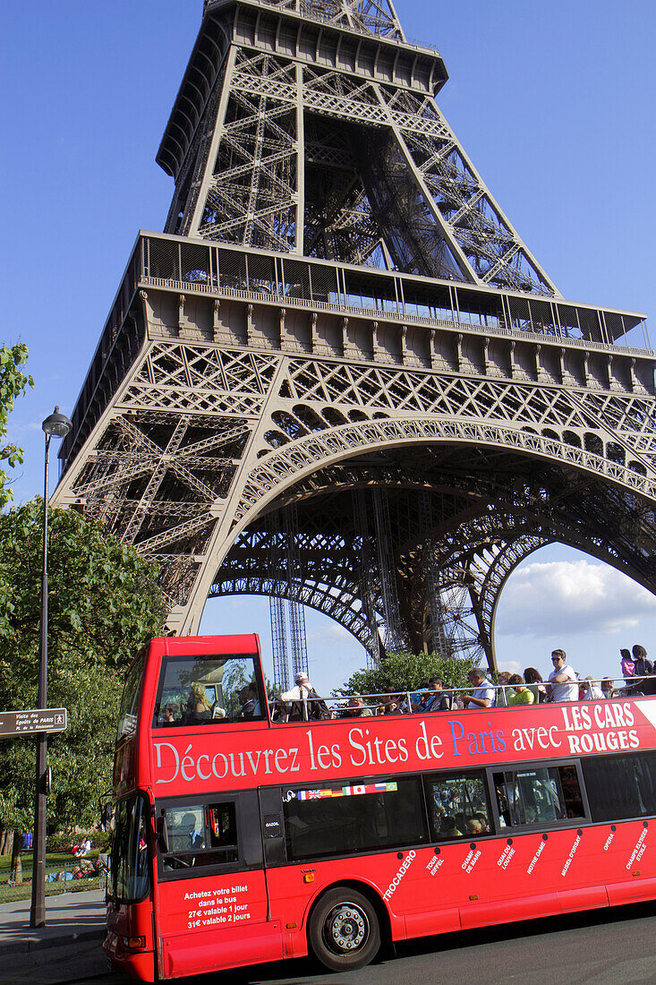 France, Europe, French, Paris, 7th arrondissement, Quai Branly, Eiffel Tower, base, legs, pillars, double decker bus motor coach, red,.