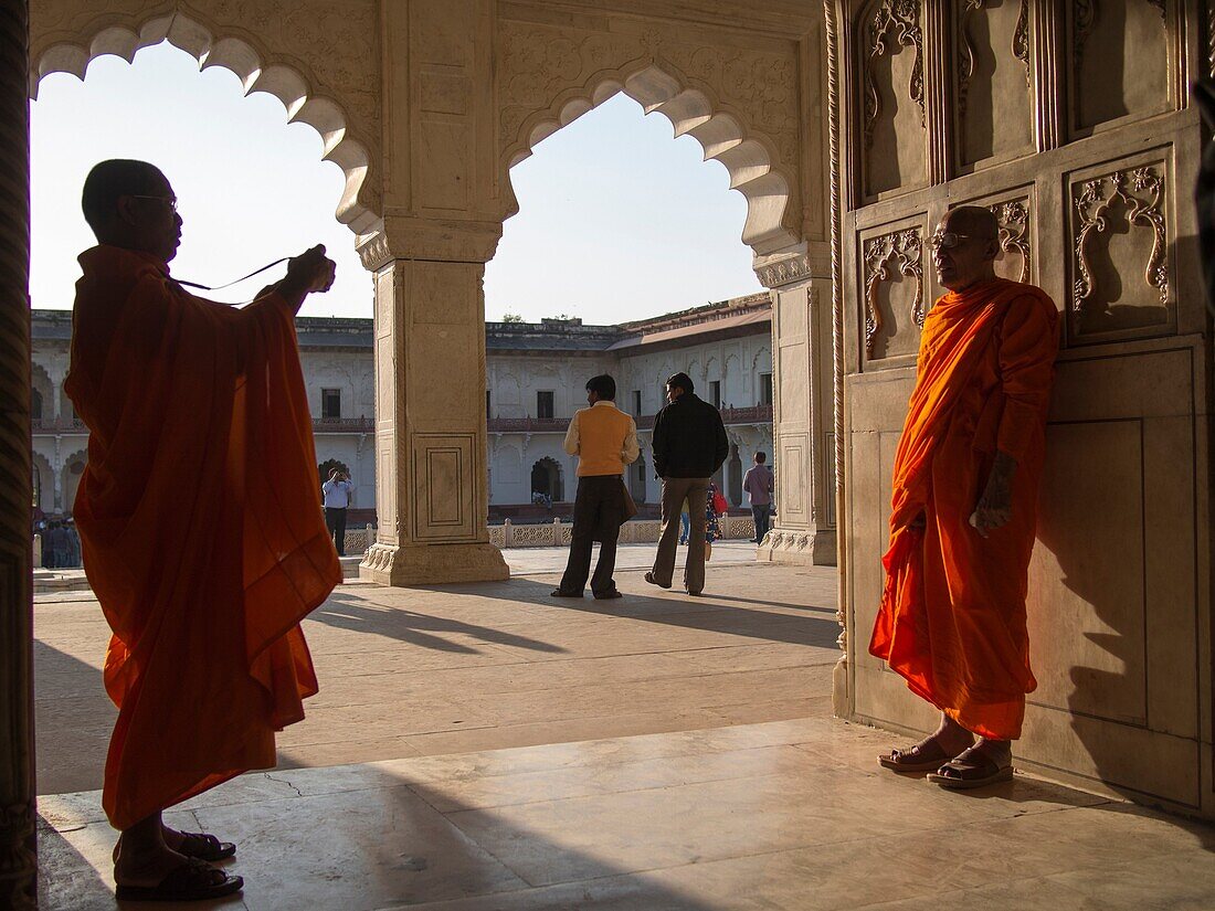 Men in religious dress photographing at temple in Agra, Uttar Pradesh, India.