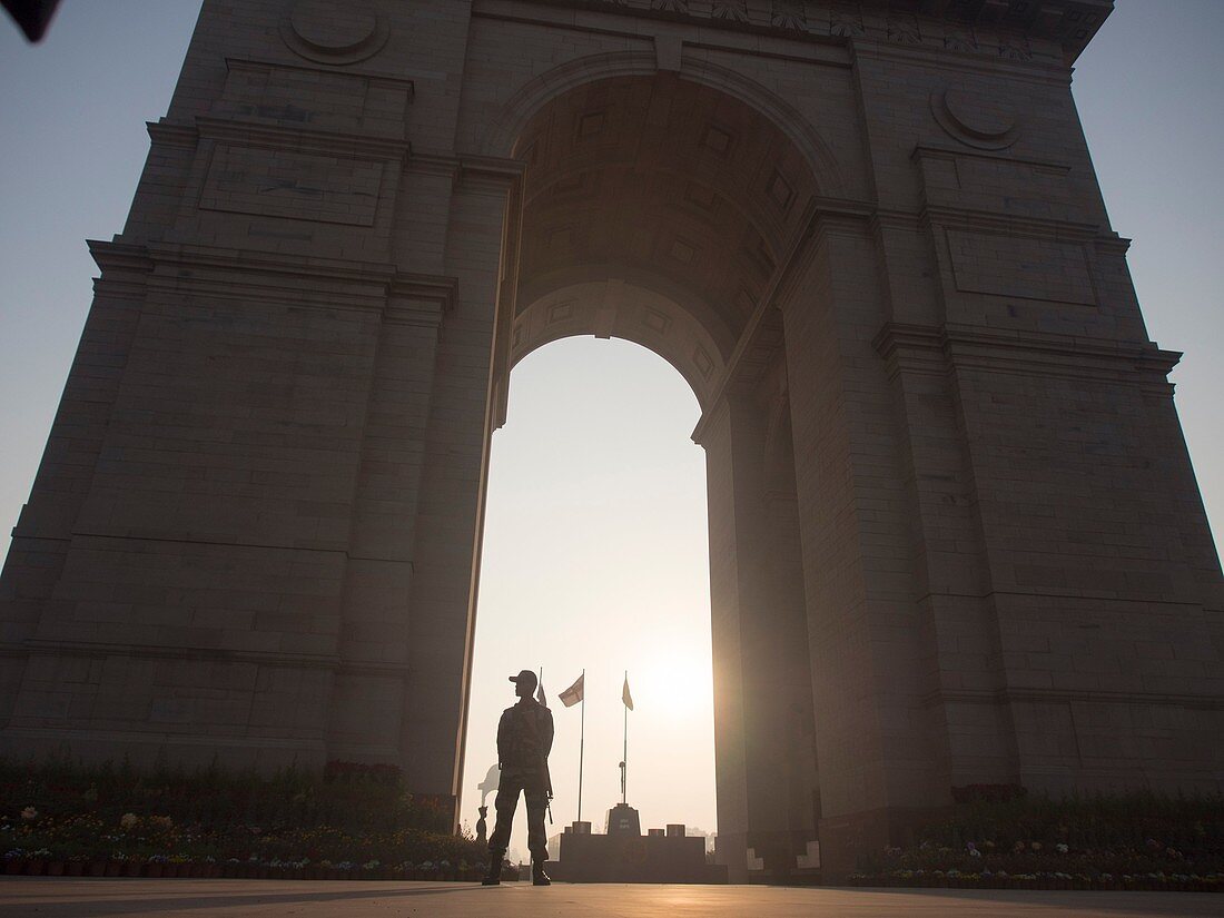 Security guard standing at India Gate in New Delhi, India.