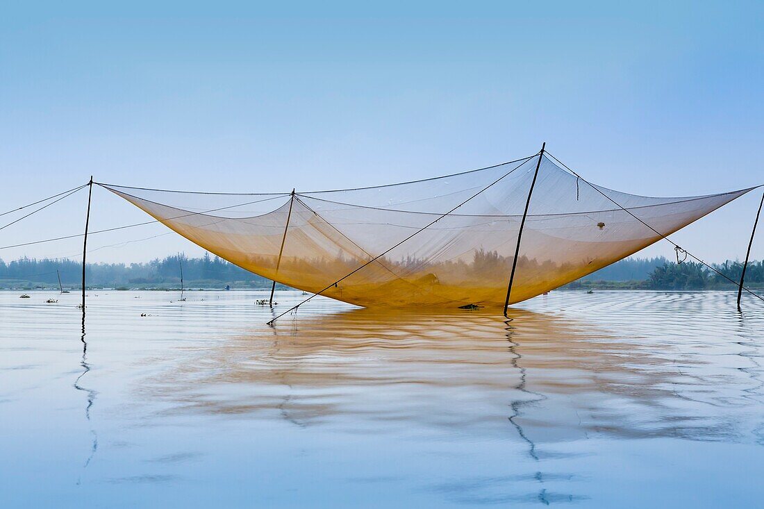 Large fishing nets in the Thu Bon River near Hoi An, Vietnam, Asia.
