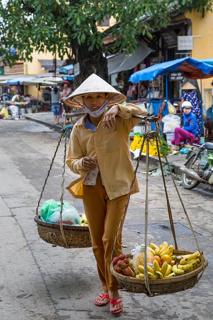 An outdoor fruit and vegetable market in Hoi An, Vietnam, Asia.