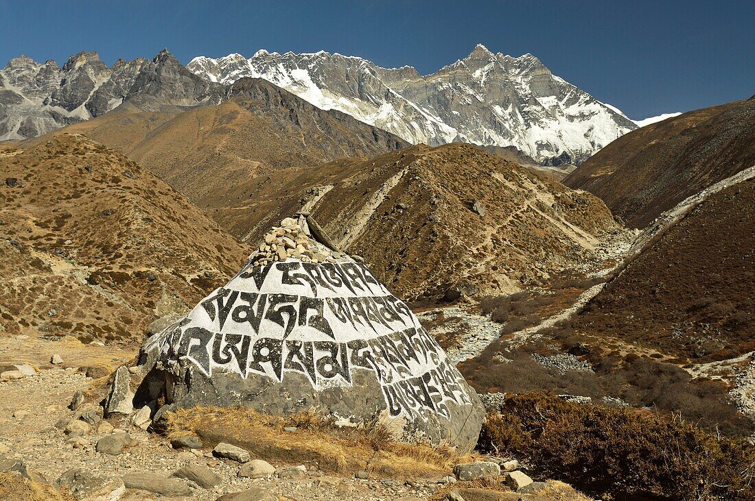Stones with prayers. Lhotse mountain (8501 m) in the background.Sagarmatha National Park (Nepal).